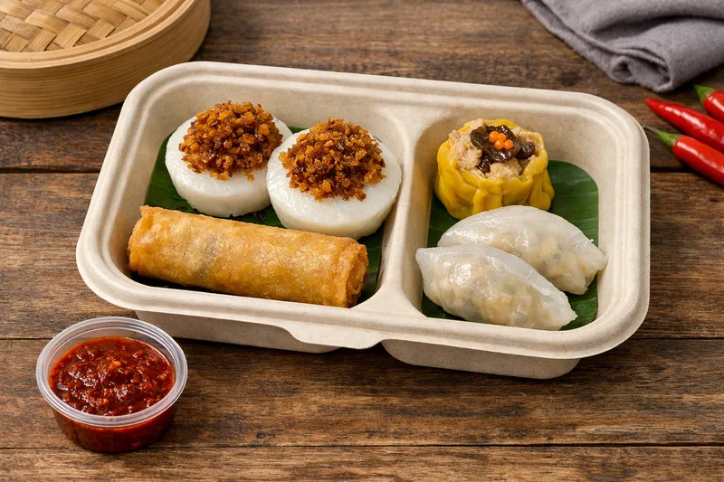 Halal dim sum breakfast bento in Singapore with fried carrot cake, spring roll, chicken siew mai, soon kueh and sambal chilli