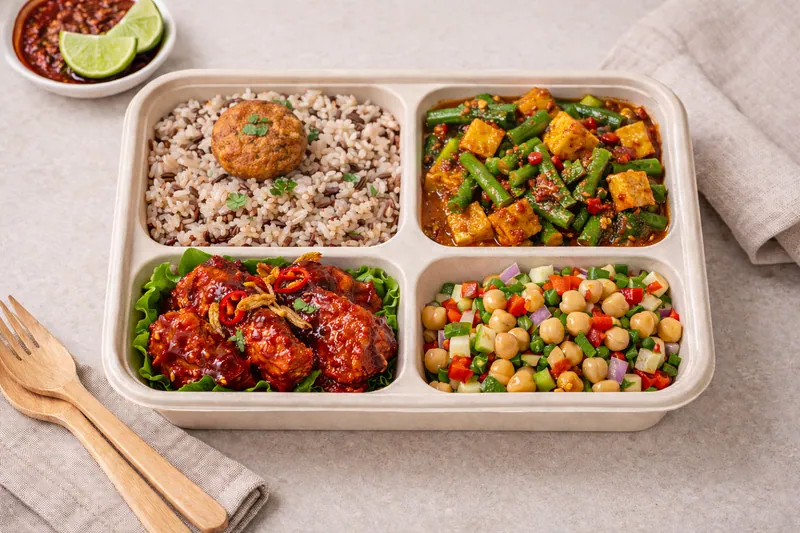 Healthy halal bento meal with wholegrain rice, grilled fish and stir fried vegetables