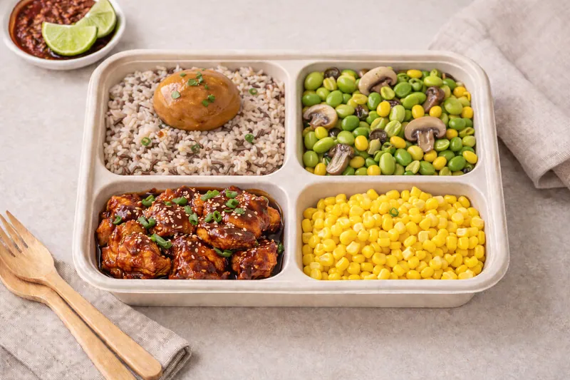 Healthier choice halal bento with brown rice, baked chicken, roasted vegetables and chickpea salad