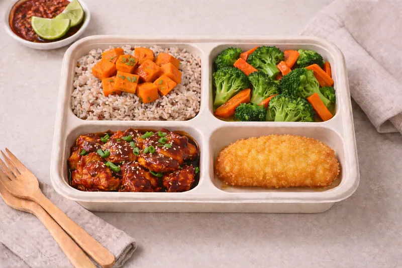Healthier choice halal bento with mixed brown rice, broccoli with carrot, Korean chicken bulgogi, breaded fish fillet and sweet potato