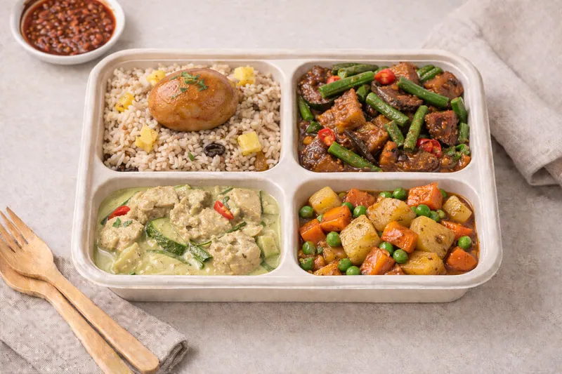 Healthier choice halal bento with wholegrain Thai pineapple rice, chilli bean eggplant with longbean, Thai green curry chicken and stewed egg